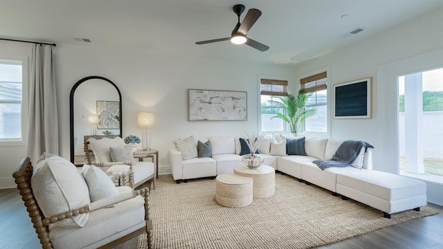 living room featuring wood finished floors, a ceiling fan, and baseboards
