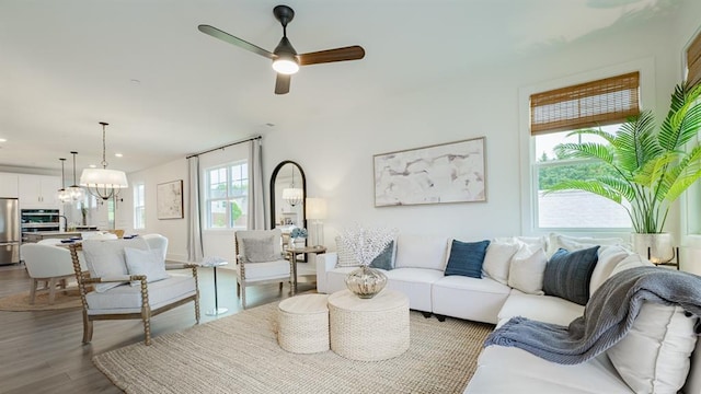 living room featuring wood finished floors, a ceiling fan, and recessed lighting