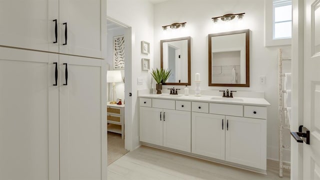 full bathroom with double vanity and baseboards
