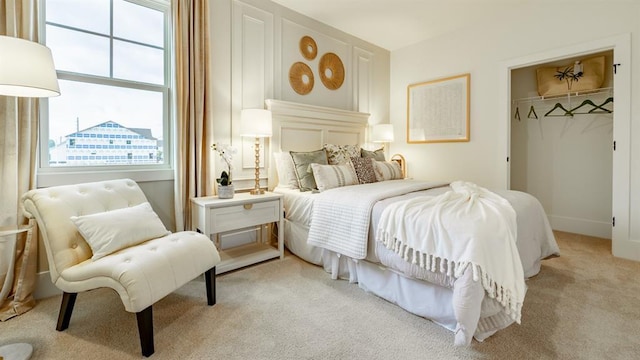 bedroom featuring light carpet, a closet, and a spacious closet