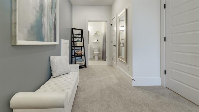 corridor featuring carpet flooring and baseboards