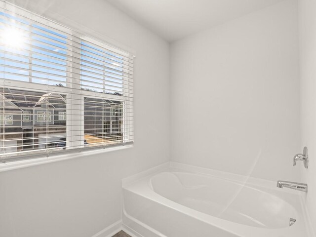 carpeted living area featuring baseboards and visible vents