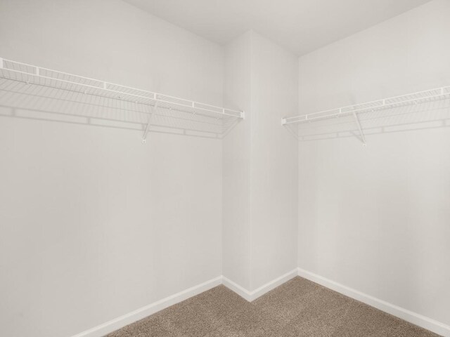 carpeted bedroom featuring a nursery area, visible vents, and baseboards