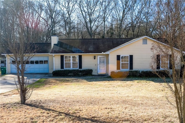 ranch-style home featuring a garage and a front lawn