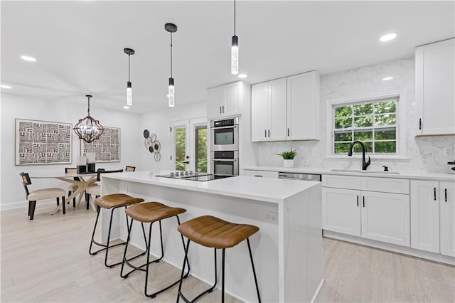3614 N Druid Hills Rd N, Decatur, GA 30033 - kitchen with a sink, recessed lighting, a kitchen island, tasteful backsplash, and white cabinets