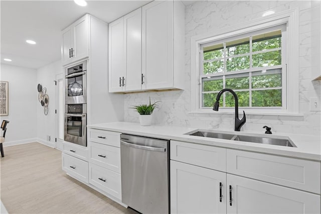 3614 N Druid Hills Rd N, Decatur, GA 30033 - kitchen with stainless steel appliances, a sink, decorative backsplash, recessed lighting, and light countertops