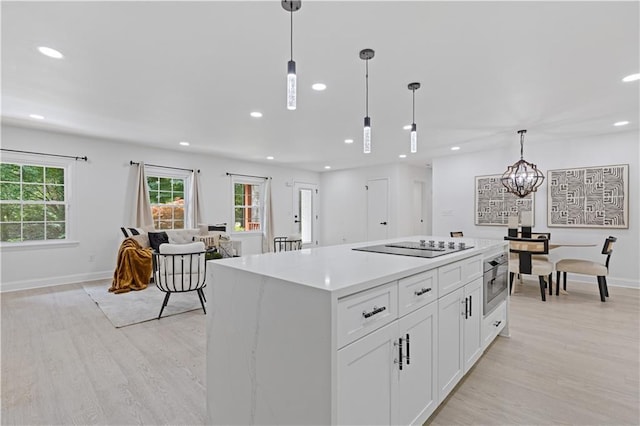 3614 N Druid Hills Rd N, Decatur, GA 30033 - kitchen featuring recessed lighting, light wood finished floors, a kitchen island, healthy amount of natural light, and white cabinetry