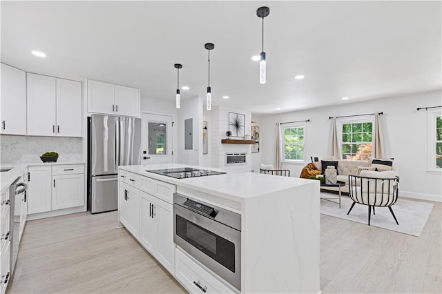 3614 N Druid Hills Rd N, Decatur, GA 30033 - kitchen featuring appliances with stainless steel finishes, light wood-type flooring, recessed lighting, open floor plan, and white cabinetry