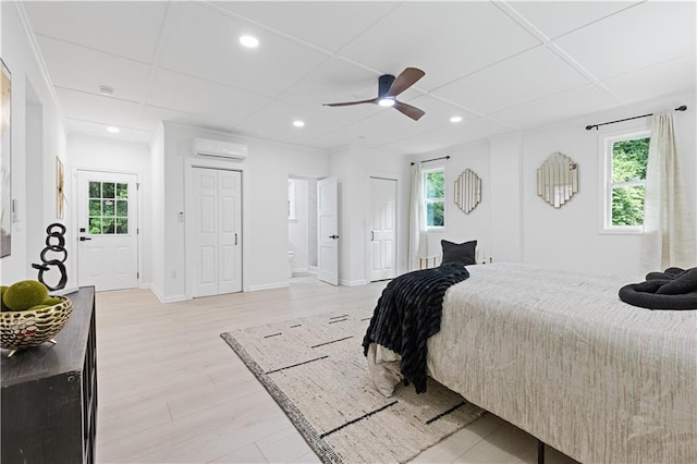 3614 N Druid Hills Rd N, Decatur, GA 30033 - bedroom featuring a wall mounted AC, light wood-style floors, multiple windows, and recessed lighting
