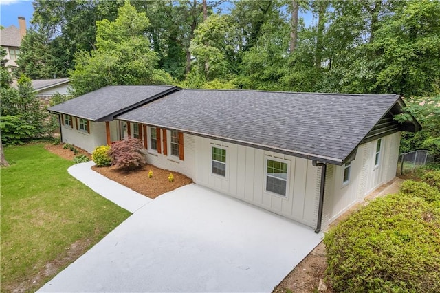 3614 N Druid Hills Rd N, Decatur, GA 30033 - single story home with a shingled roof, board and batten siding, a front yard, and concrete driveway