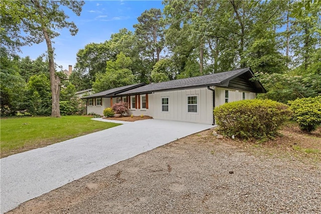 3614 N Druid Hills Rd N, Decatur, GA 30033 - ranch-style house with driveway, board and batten siding, a front yard, and view of wooded area