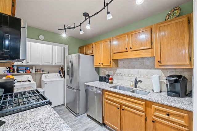 202 Berkeley Woods Dr, Duluth, GA 30096 - kitchen with a sink, appliances with stainless steel finishes, separate washer and dryer, decorative backsplash, and light stone countertops