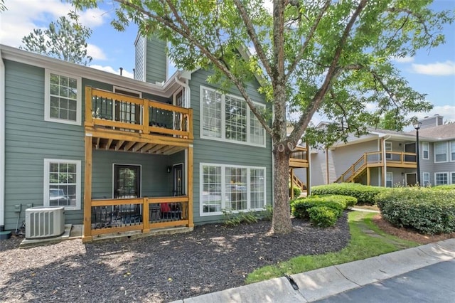 202 Berkeley Woods Dr, Duluth, GA 30096 - back of property featuring central air condition unit, a chimney, and a balcony
