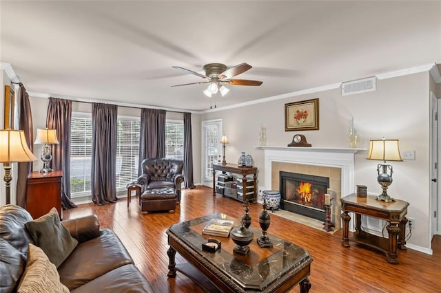 202 Berkeley Woods Dr, Duluth, GA 30096 - living area with ceiling fan, crown molding, a tile fireplace, wood finished floors, and baseboards