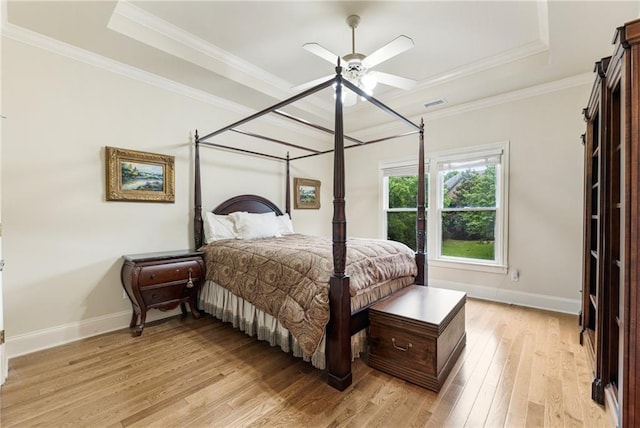 8970 Moor Park Run, Duluth, GA 30097 - bedroom featuring a raised ceiling, light wood-style floors, baseboards, ornamental molding, and ceiling fan