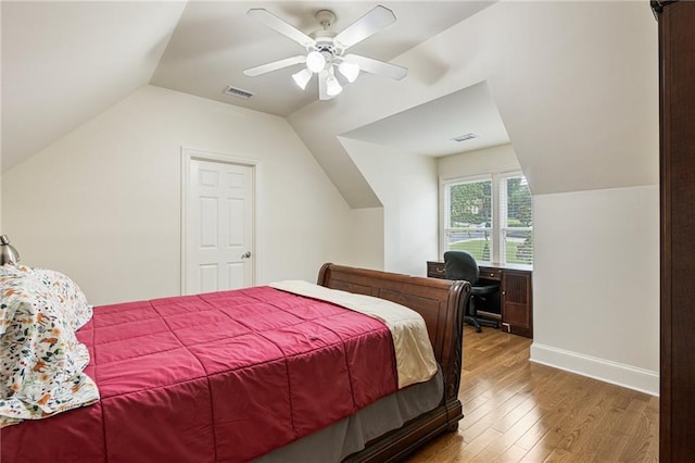 8970 Moor Park Run, Duluth, GA 30097 - bedroom featuring wood finished floors, lofted ceiling, ceiling fan, baseboards, and a desk