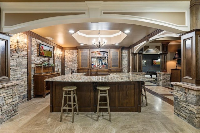 8970 Moor Park Run, Duluth, GA 30097 - bar area with arched walkways, ornate columns, light marble finish floors, ornamental molding, and a chandelier