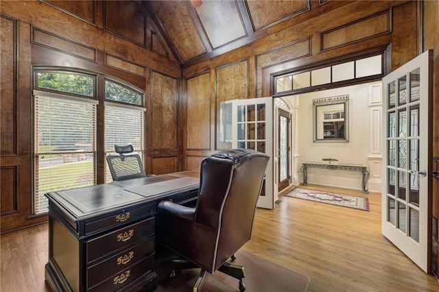 8970 Moor Park Run, Duluth, GA 30097 - home office with french doors, a decorative wall, wood finished floors, high vaulted ceiling, and wooden walls