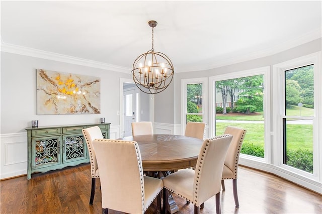 dining room featuring a decorative wall, a wainscoted wall, a notable chandelier, ornamental molding, and dark wood-style floors