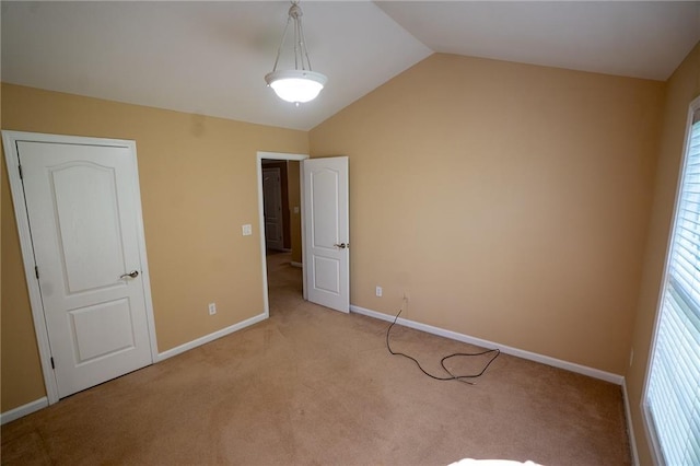 2548 Gadsen Walk, Duluth, GA 30097 - unfurnished bedroom featuring baseboards, vaulted ceiling, multiple windows, and light carpet