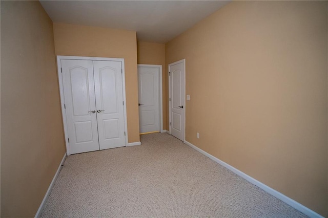 2548 Gadsen Walk, Duluth, GA 30097 - unfurnished bedroom featuring a closet, baseboards, and light carpet