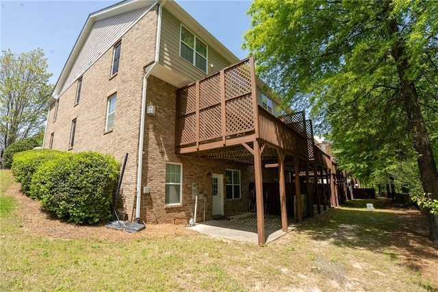 2548 Gadsen Walk, Duluth, GA 30097 - rear view of house featuring brick siding, a yard, and a wooden deck