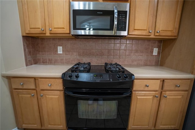 2548 Gadsen Walk, Duluth, GA 30097 - kitchen with black range with gas cooktop, light countertops, backsplash, and stainless steel microwave