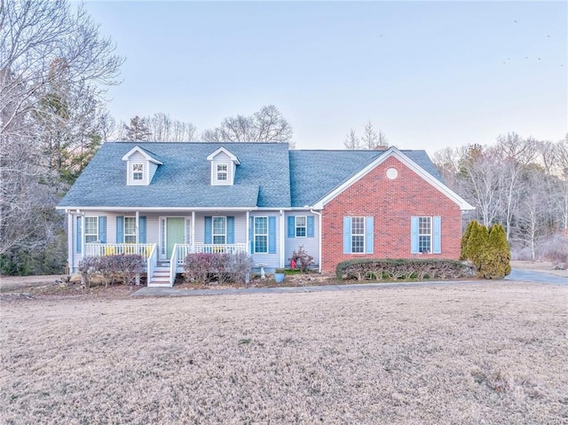 cape cod-style house with covered porch