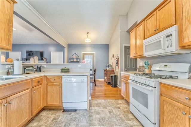 kitchen featuring sink, white appliances, and kitchen peninsula