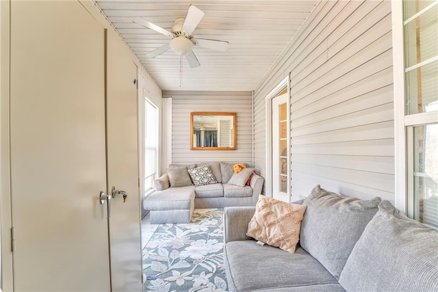 sunroom / solarium featuring ceiling fan and wood ceiling