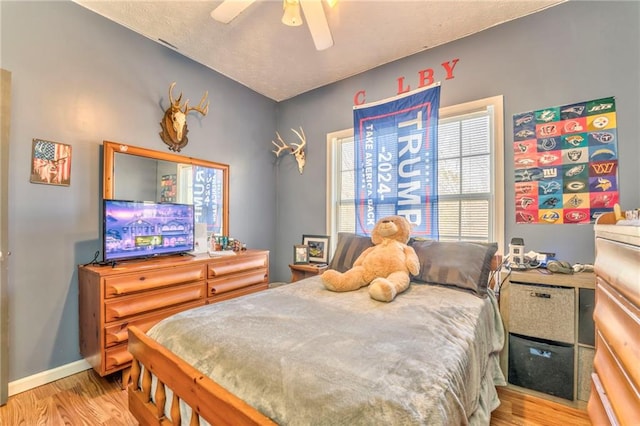 bedroom with ceiling fan and light hardwood / wood-style flooring