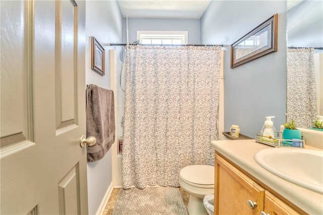 full bathroom featuring toilet, vanity, and shower / bathtub combination with curtain