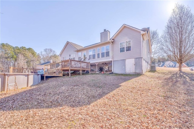 back of property featuring a wooden deck