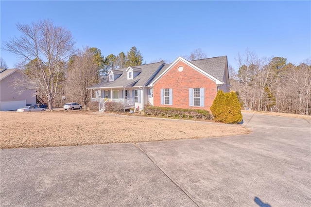 new england style home with a porch