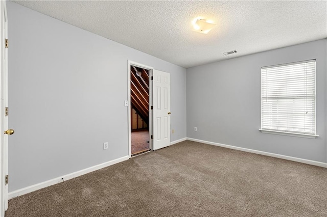 unfurnished bedroom with a closet, carpet flooring, and a textured ceiling