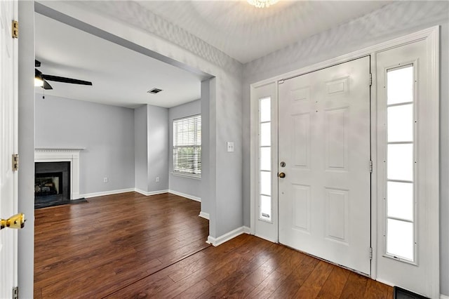 entryway featuring ceiling fan and dark wood-type flooring