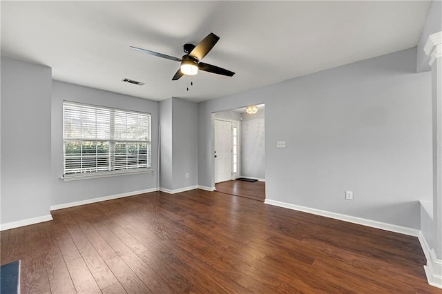 empty room with ceiling fan and dark hardwood / wood-style floors