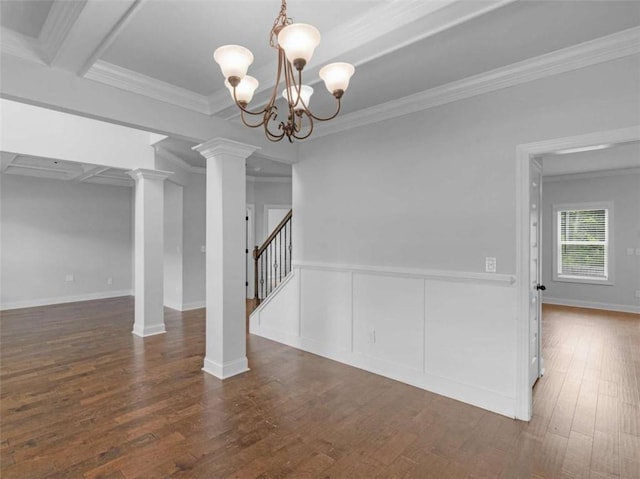 149 Elkins Blvd, Locust Grove, GA 30248 - unfurnished dining area featuring wood finished floors, ornamental molding, decorative columns, stairway, and a chandelier
