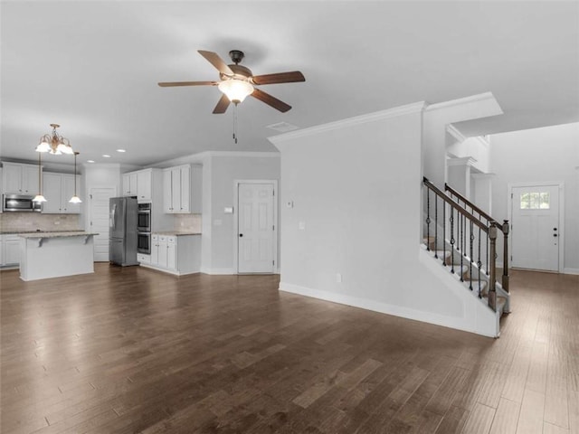 149 Elkins Blvd, Locust Grove, GA 30248 - unfurnished living room with ceiling fan, a chandelier, dark wood-style flooring, stairway, and recessed lighting