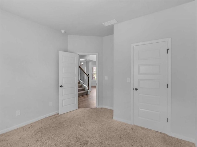 149 Elkins Blvd, Locust Grove, GA 30248 - carpeted spare room with stairway and baseboards