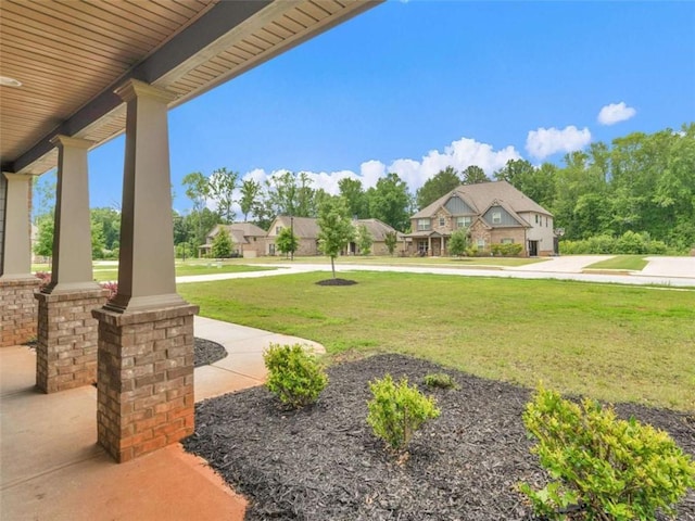 149 Elkins Blvd, Locust Grove, GA 30248 - view of grassy yard with covered porch and a residential view