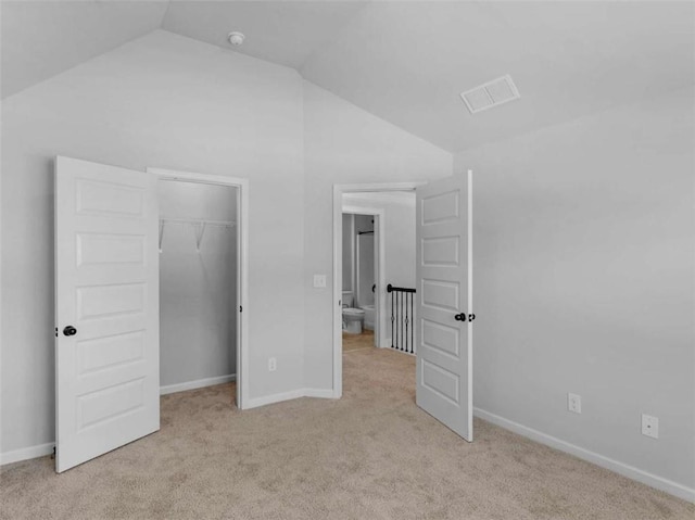 149 Elkins Blvd, Locust Grove, GA 30248 - unfurnished bedroom featuring lofted ceiling, light carpet, a walk in closet, and a closet