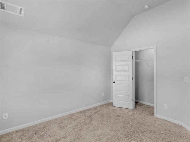 149 Elkins Blvd, Locust Grove, GA 30248 - unfurnished bedroom with vaulted ceiling, carpet, a spacious closet, and a closet