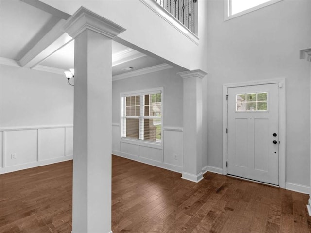 149 Elkins Blvd, Locust Grove, GA 30248 - entrance foyer with decorative columns, wood finished floors, ornamental molding, a wainscoted wall, and a chandelier