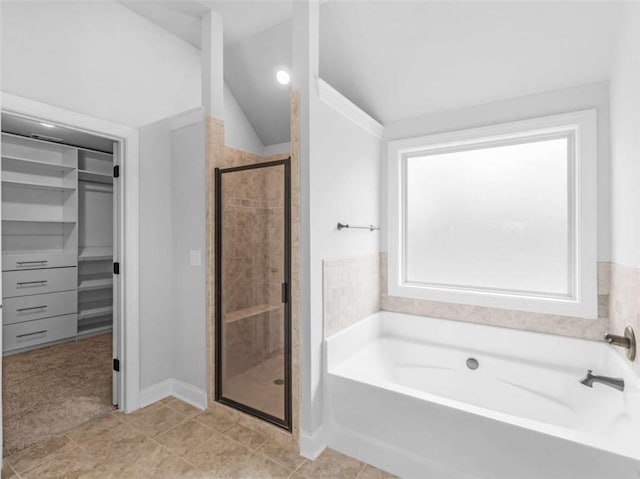149 Elkins Blvd, Locust Grove, GA 30248 - full bath with a garden tub, a stall shower, a walk in closet, and vaulted ceiling
