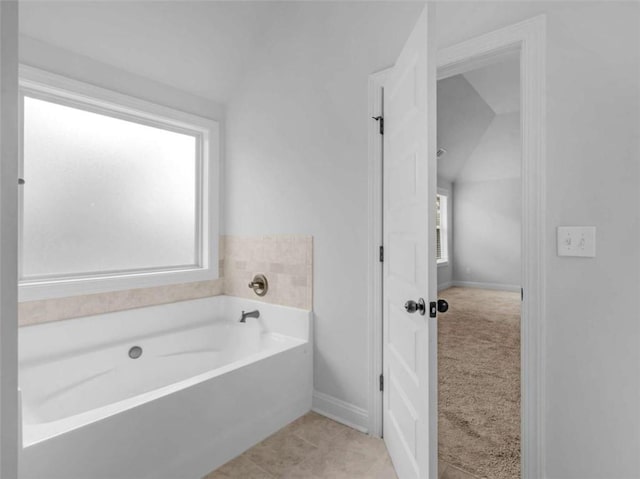 149 Elkins Blvd, Locust Grove, GA 30248 - bathroom featuring a garden tub and baseboards