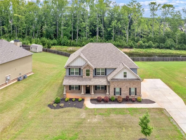 149 Elkins Blvd, Locust Grove, GA 30248 - craftsman-style house featuring a porch, board and batten siding, a front yard, brick siding, and a shingled roof