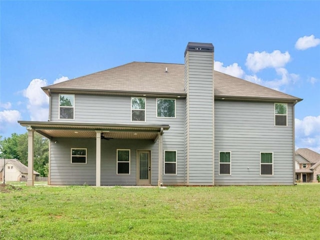 149 Elkins Blvd, Locust Grove, GA 30248 - back of property with a lawn and a chimney