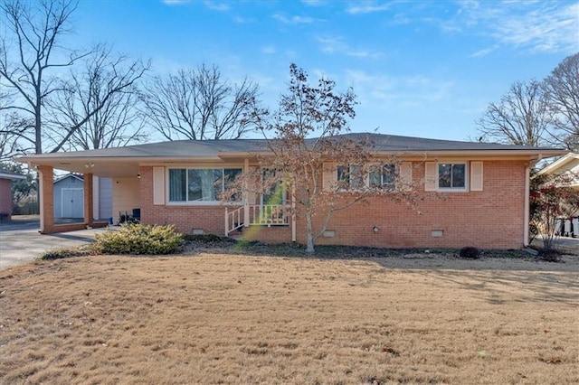 view of front facade with a front yard and a carport