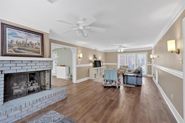 living room with ceiling fan, ornamental molding, a fireplace, and hardwood / wood-style floors